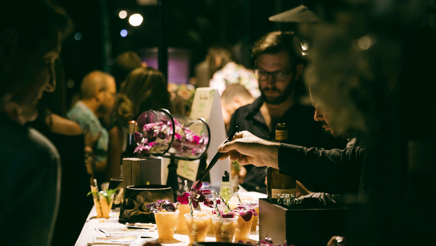 Server garnishing a cocktail at food & wine event at Kimpton Surfcomber Hotel