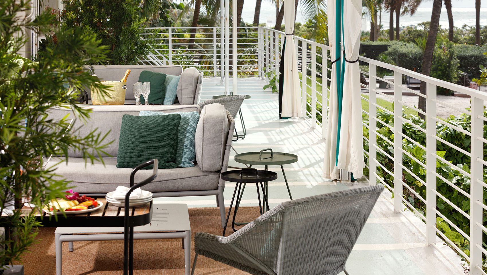 upstairs deck of cabanas with chairs and sofas